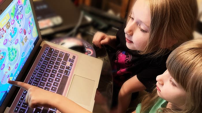 Two school girls learning on a laptop with the ABC Reading Eggs program